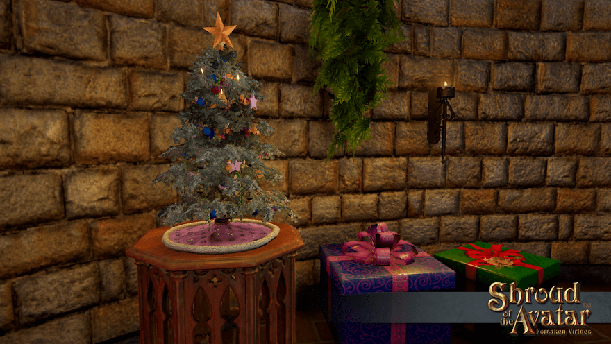 A yule tree with a pink skirt sits on a octagonal side table by a pair of gift boxes.