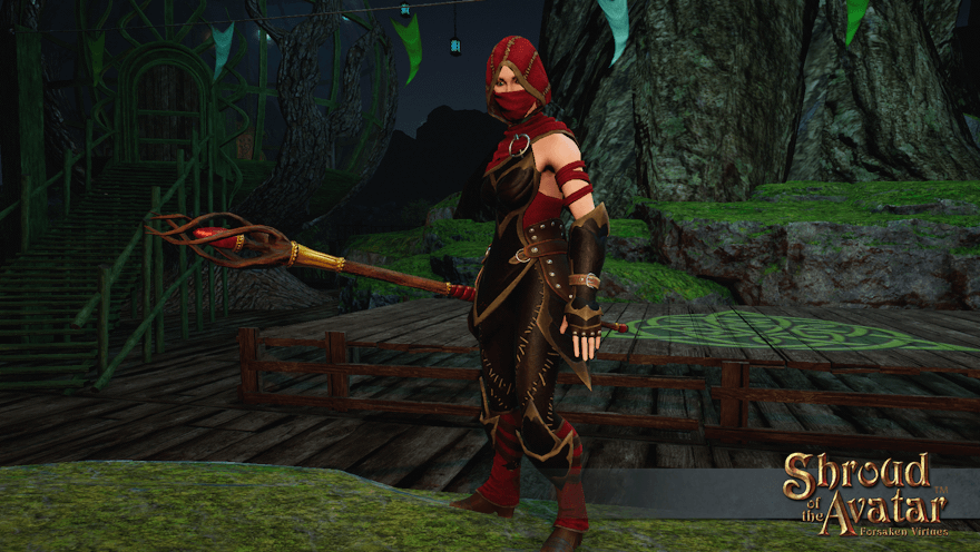 An elf wielding a staff with a red gem stands ready at the central bonfire in Yew.