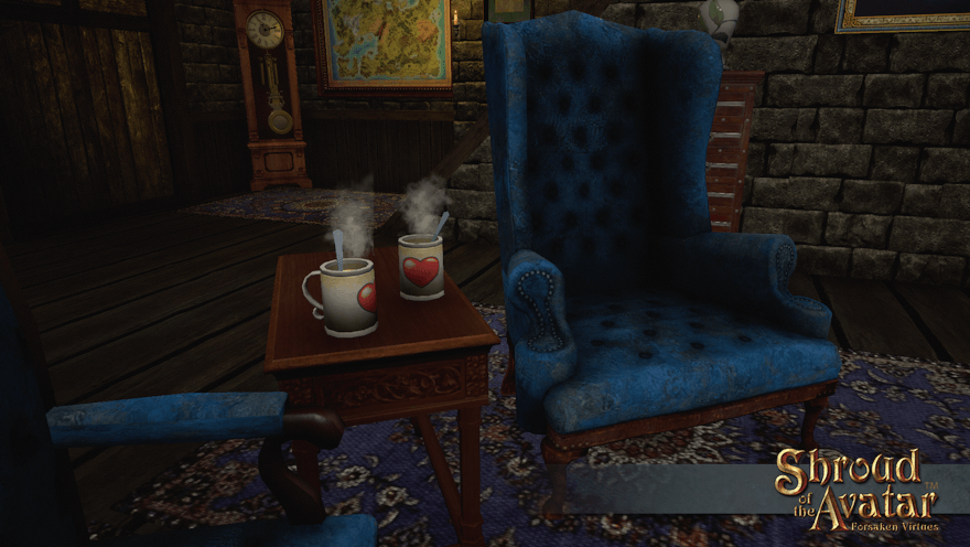 Two steaming stoneware mugs with spoons, decorated with hearts, sit on a table between two fireside velvet armchairs.