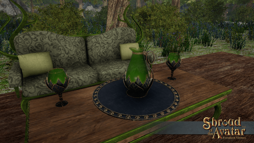 A coffee table on a Yew patio holds a black and gold tray with leaf decorations, a green glass pitcher with a dark metal leaf base, and two matching goblets.