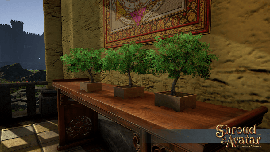 Wooden boxes hold three small cherry trees in full leaf in a row atop a wooden altar on a grassland balcony.